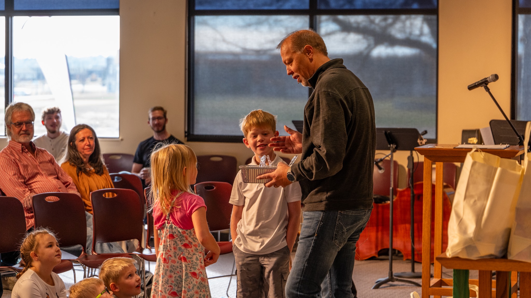 Pastor Matt Furister speaking with children during a message at The Anchor